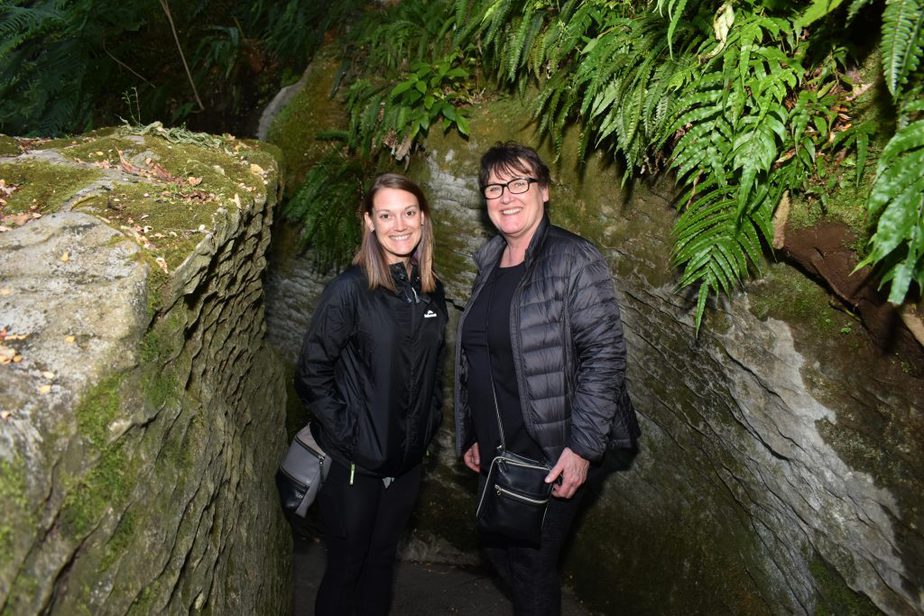 Mom and daughter standing at the entrance to the Glow Worm Caves in Te Anau, New Zealand